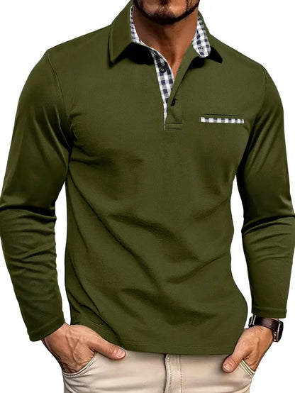 Man wearing the polo in olive green, with black and white gingham trim on the collar, placket and chest pocket, hands in beige trousers. 3