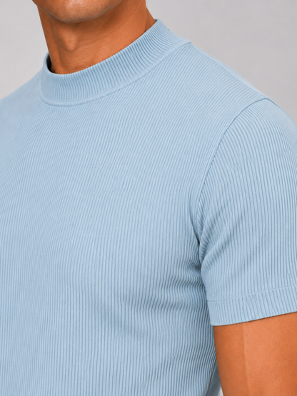 Close-up of the light blue top showing fine vertical ribbing, mock neck collar and short sleeve hem. 7