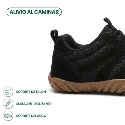 Close-up of the heel of the black mesh and suede shoe with a tan sole, with icons for heel, grip and arch support. 22