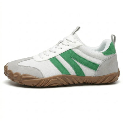 Side view of the white shoe with green suede stripes, grey toe cap and heel, and tan sole. 28
