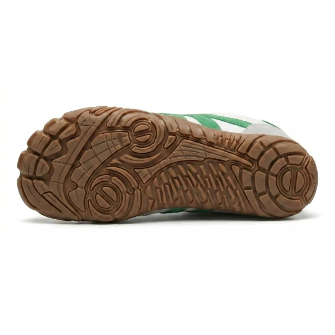 Underside of the white and green shoe showing the tan rubber sole with a detailed grip pattern and circular pods. 36
