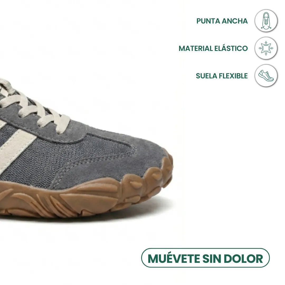 Close-up of the grey shoe's wide rounded toe and flexible sole, with icons highlighting toe room and stretch material. 5