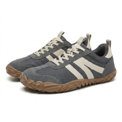 Pair of grey barefoot shoes with cream stripes and laces, shown at an angle on a plain background. 7