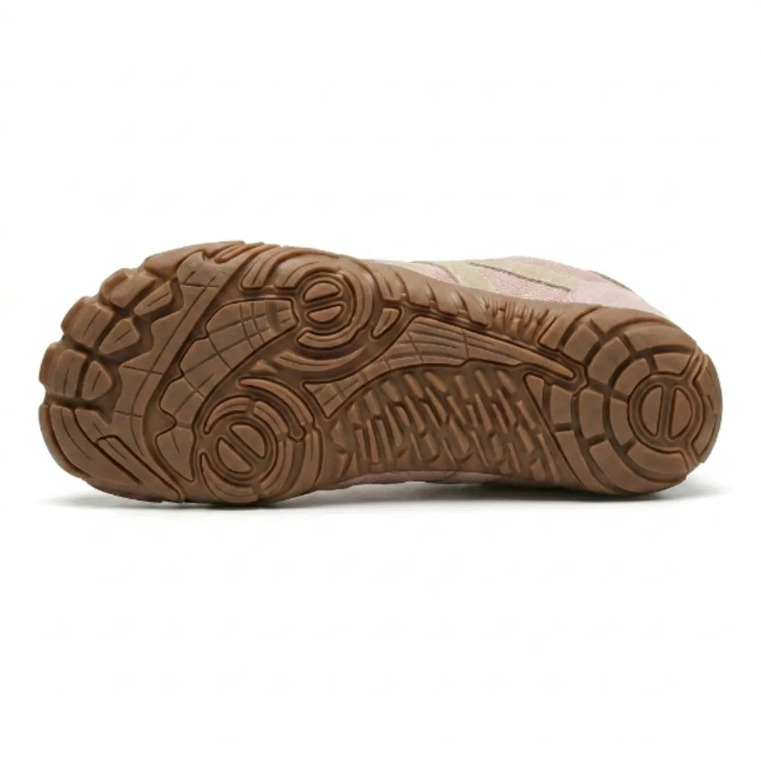 Underside of the pink shoe showing the tan rubber outsole with its textured grip pattern. 18