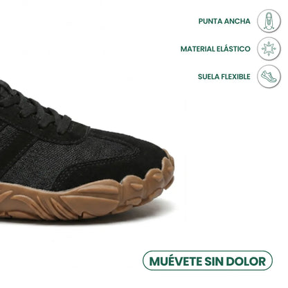 Close-up of the wide rounded toe of the black shoe with tan flexible sole, with icons for toe room, stretch and flexibility. 23