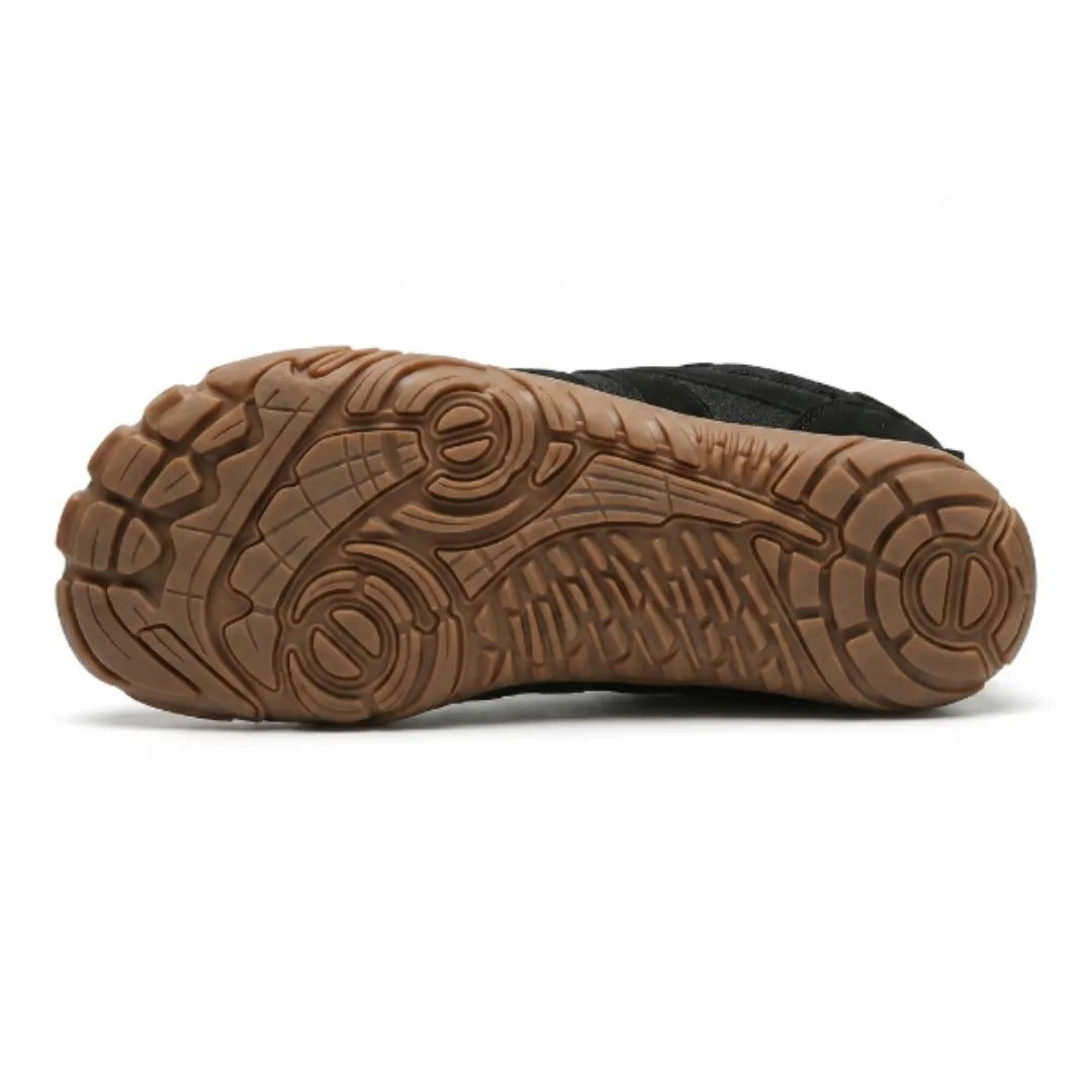 Underside of the black shoe showing the tan rubber sole with a detailed grip pattern and circular pods. 27