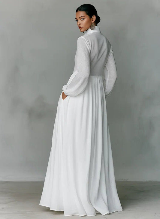 Back view of the white dress on a model glancing over her shoulder, one hand in pocket 2