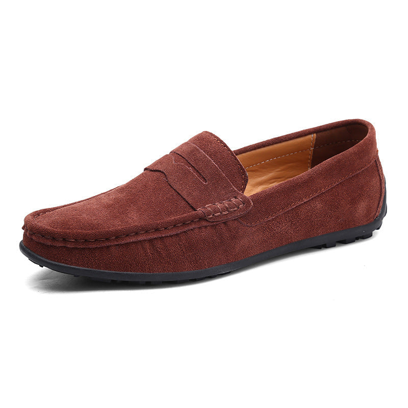 Rust brown suede penny loafer from the front three-quarter angle, with contrast tan lining and a black rubber sole. 4
