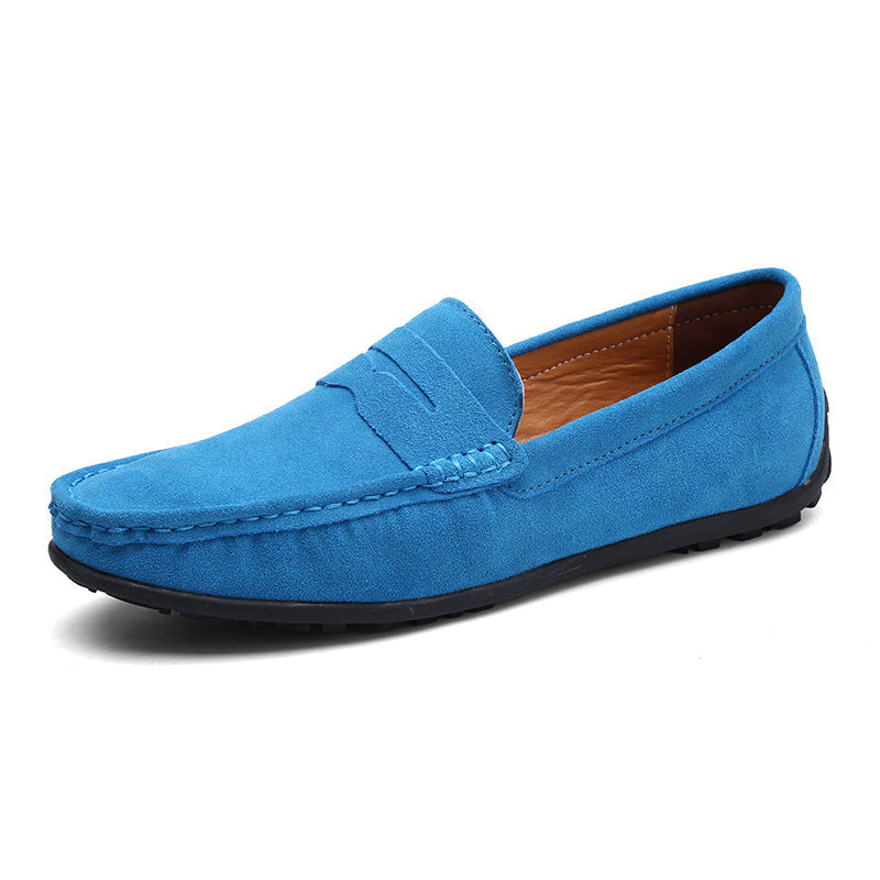 Bright sky blue suede penny loafer in front three-quarter view, with stitched vamp and tan leather interior. 5