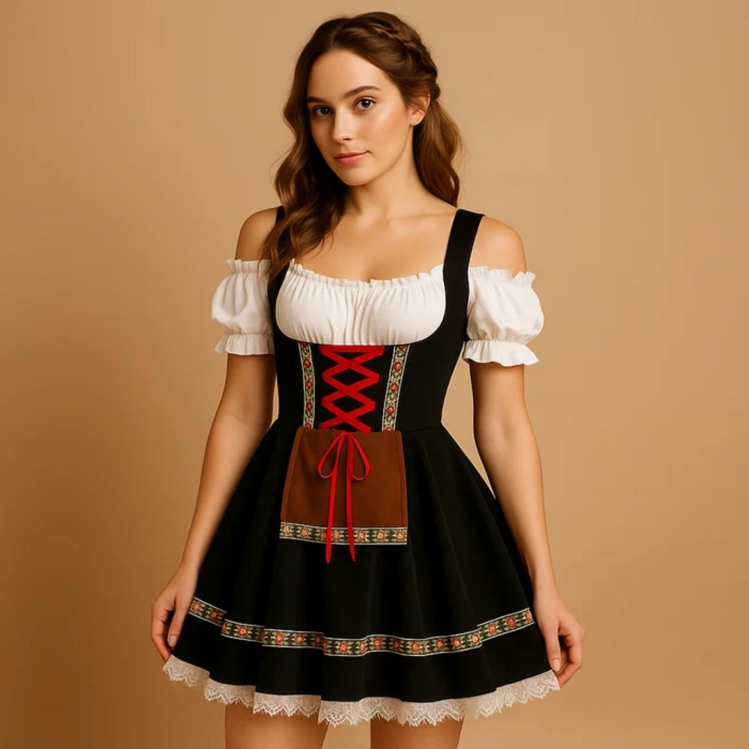 Model in a black off-shoulder dirndl with red criss-cross lacing, brown apron panel and floral trim above a lace hem 7
