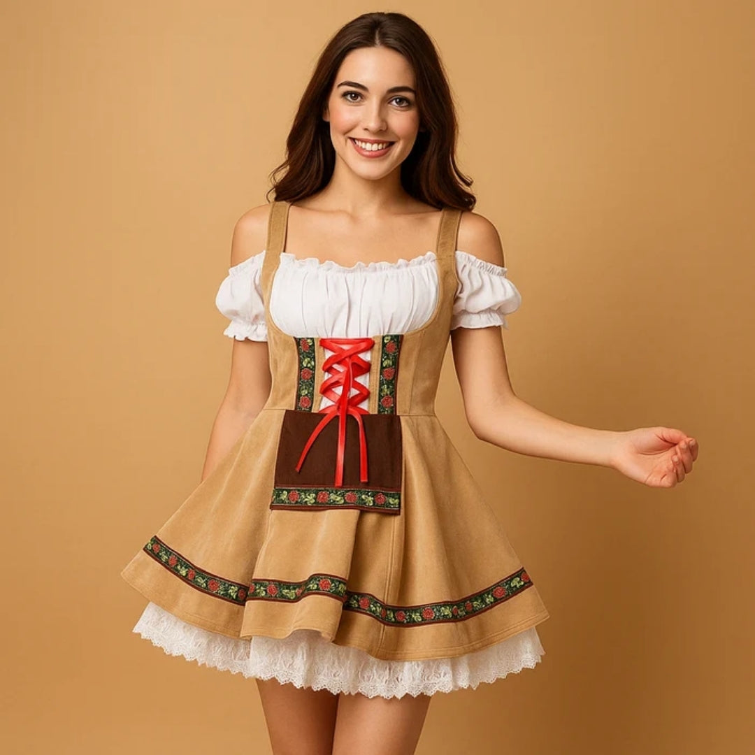 Model smiling in a tan off-shoulder dirndl with red ribbon lacing, brown apron panel and layered white lace petticoat 3