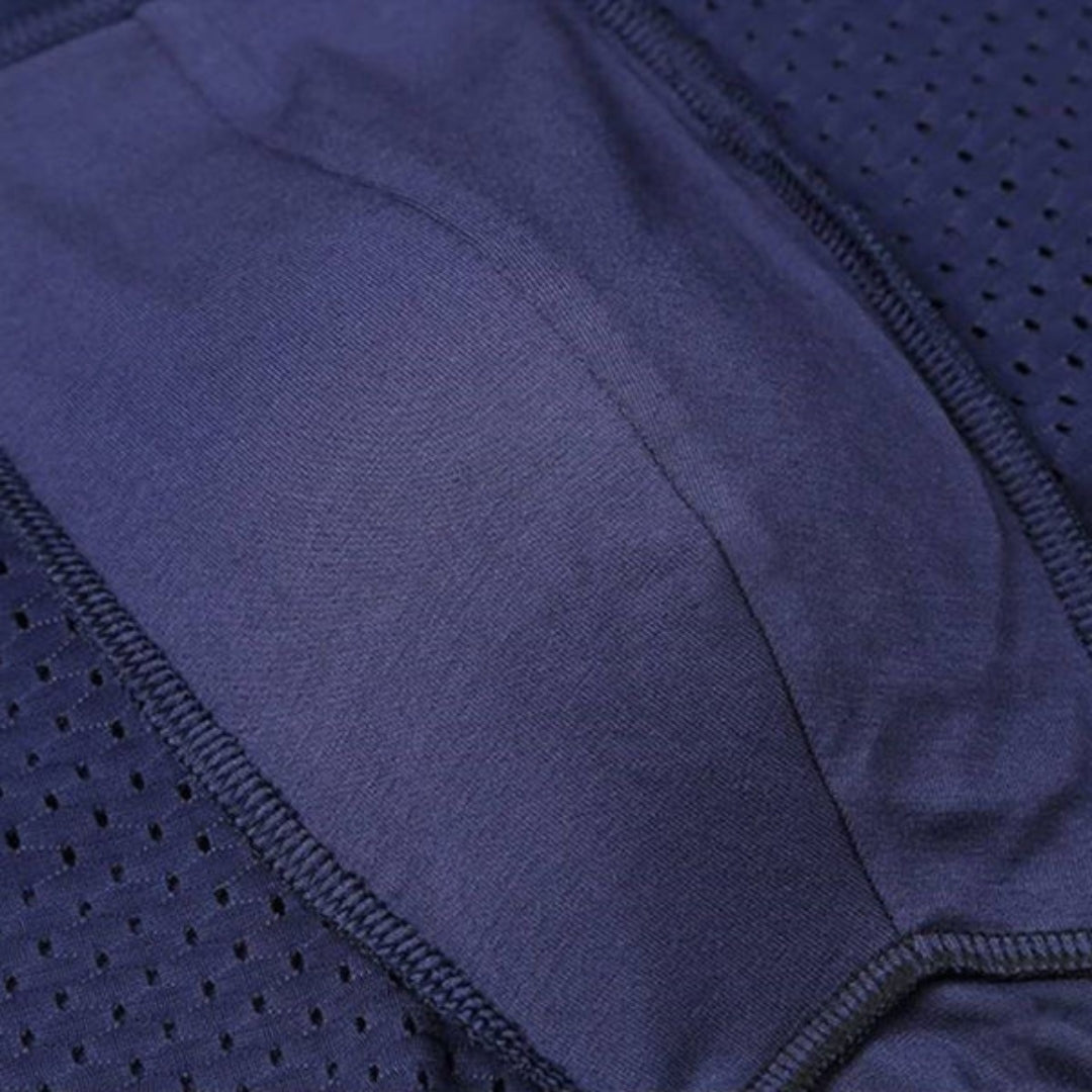 Close-up of the inside of navy boxer briefs showing the soft pouch panel, overlocked seams and mesh side sections. 8