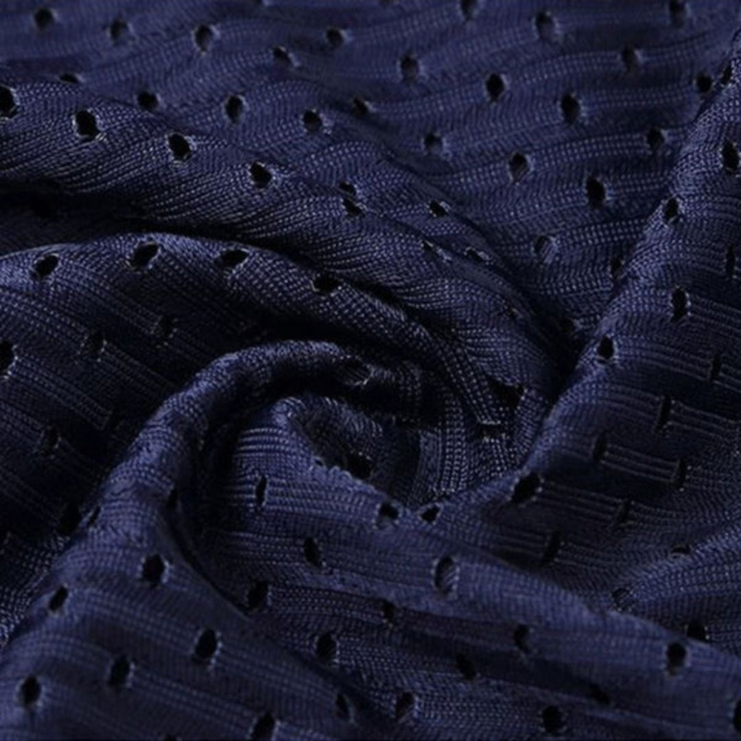 Close-up of swirled navy mesh fabric, showing the small perforations and textured weave that make the material breathable. 9