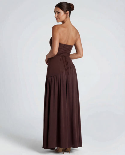 Back view of brown strapless maxi dress showing corset-style lace-up back, gathered skirt and asymmetric waistline 2