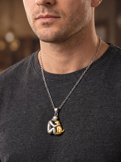 Man in a dark grey t-shirt wearing the matt silver and gold-toned dog pendant on a longer chain 11