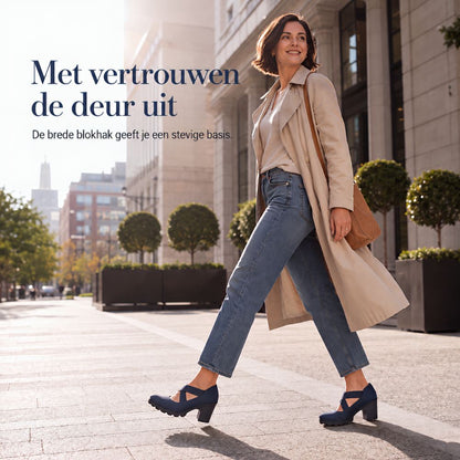 Woman in a beige trench coat and jeans striding down a city street in navy block heel shoes. 3
