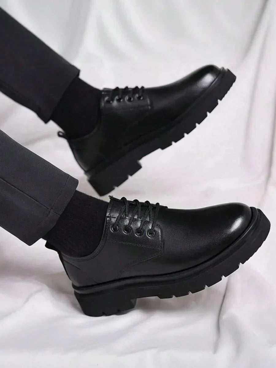 Side view of both shoes lifted mid-step, showing the chunky treaded soles against white fabric 2