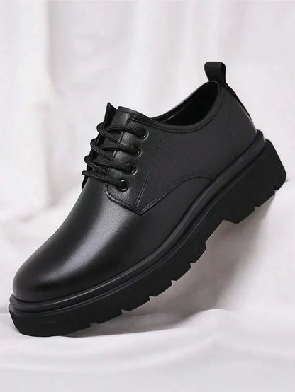 Single black derby shoe on its own against white fabric, showing the lacing and thick tread 5