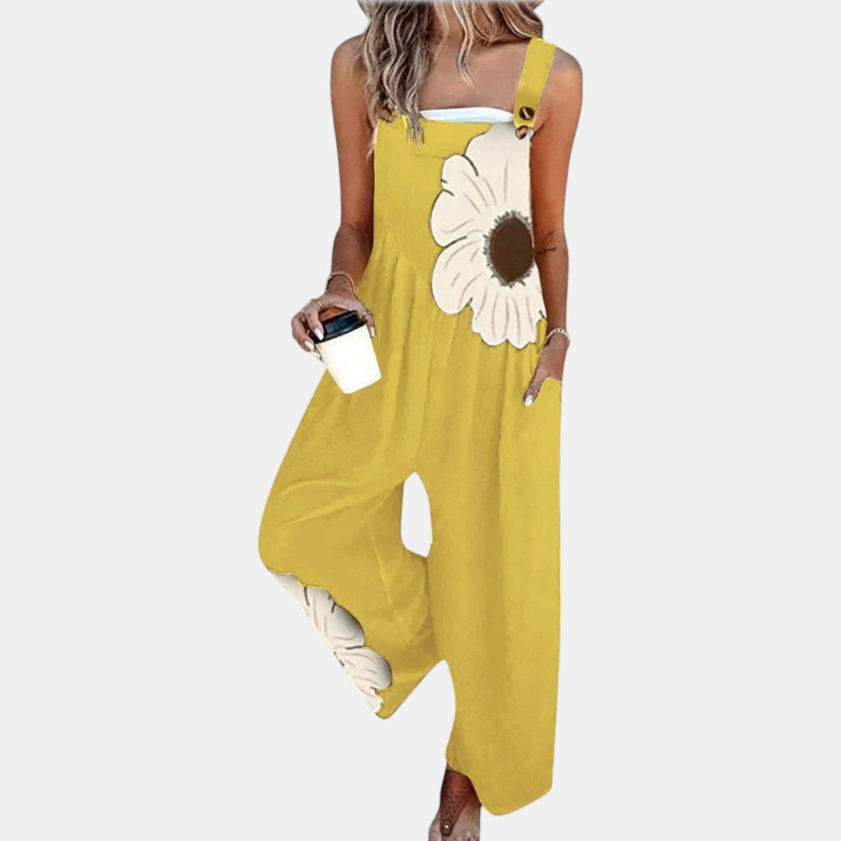 Model wearing yellow wide-leg dungarees with a large cream flower on the bib, front view 9