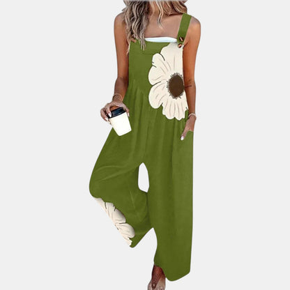 Model wearing green wide-leg dungarees with a large cream flower on the bib, front view 10