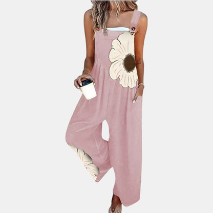 Model wearing pink wide-leg dungarees with a large cream flower on the bib, front view 7