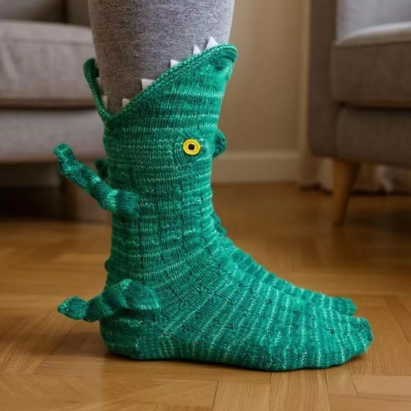 Green textured knitted sock shaped like a crocodile with white teeth at the top and a yellow eye 15