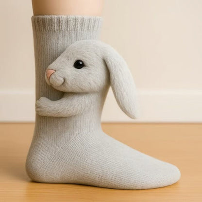 Soft grey sock with a fluffy lop-eared bunny figure hugging the leg, side view 7