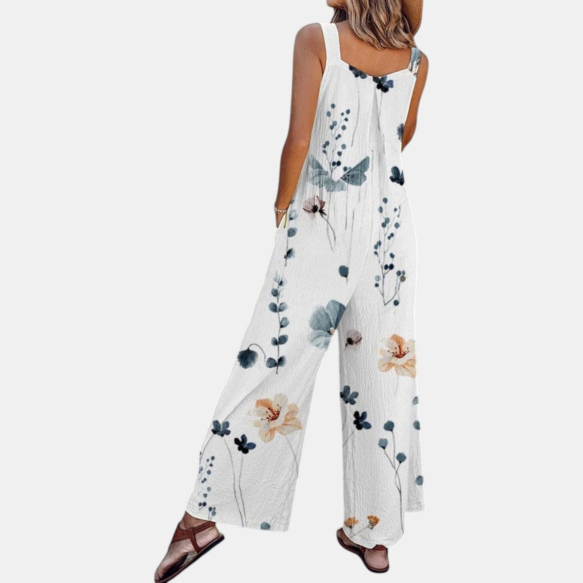 Back view of white floral dungarees on a model, showing the scattered blue and peach flower print 5