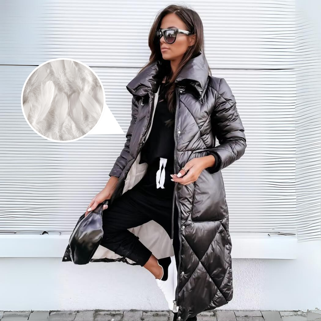 Black quilted long coat on a model, with a circular inset showing soft white feathers to illustrate the down filling. 6