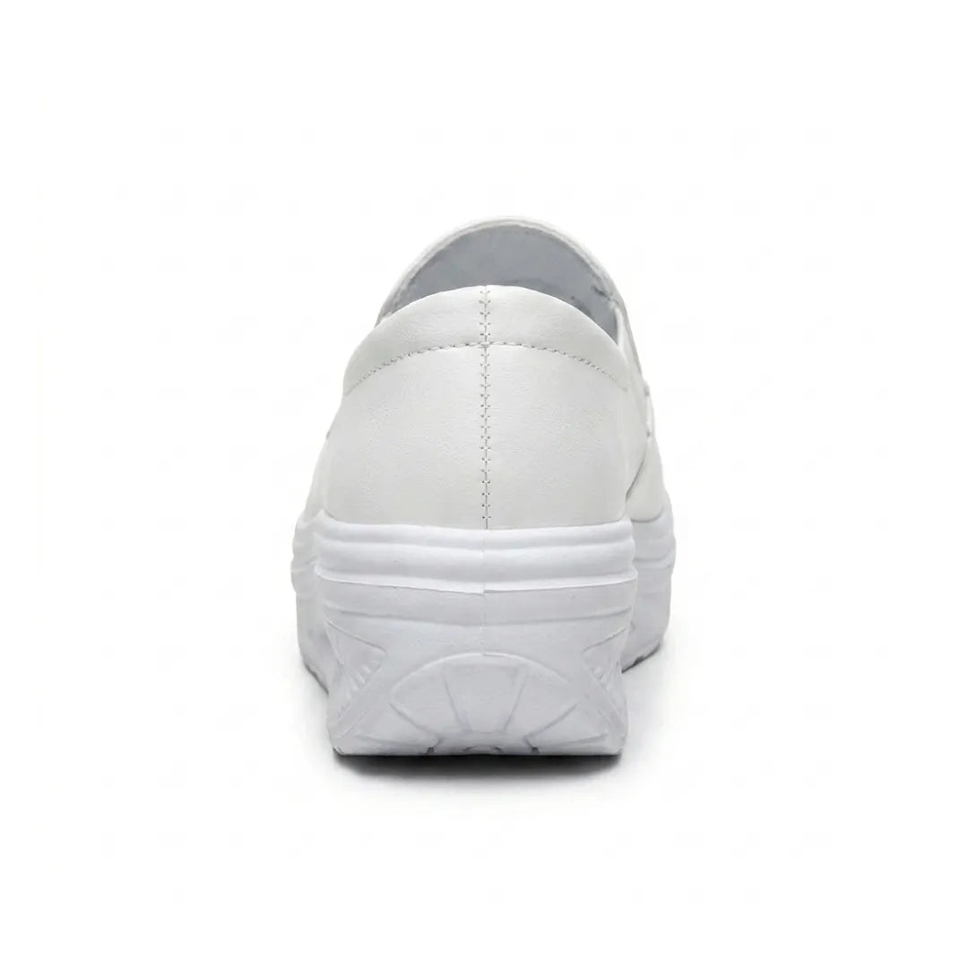 White slip-on shoe seen from behind, showing the heel stitching and curved wedge sole 18