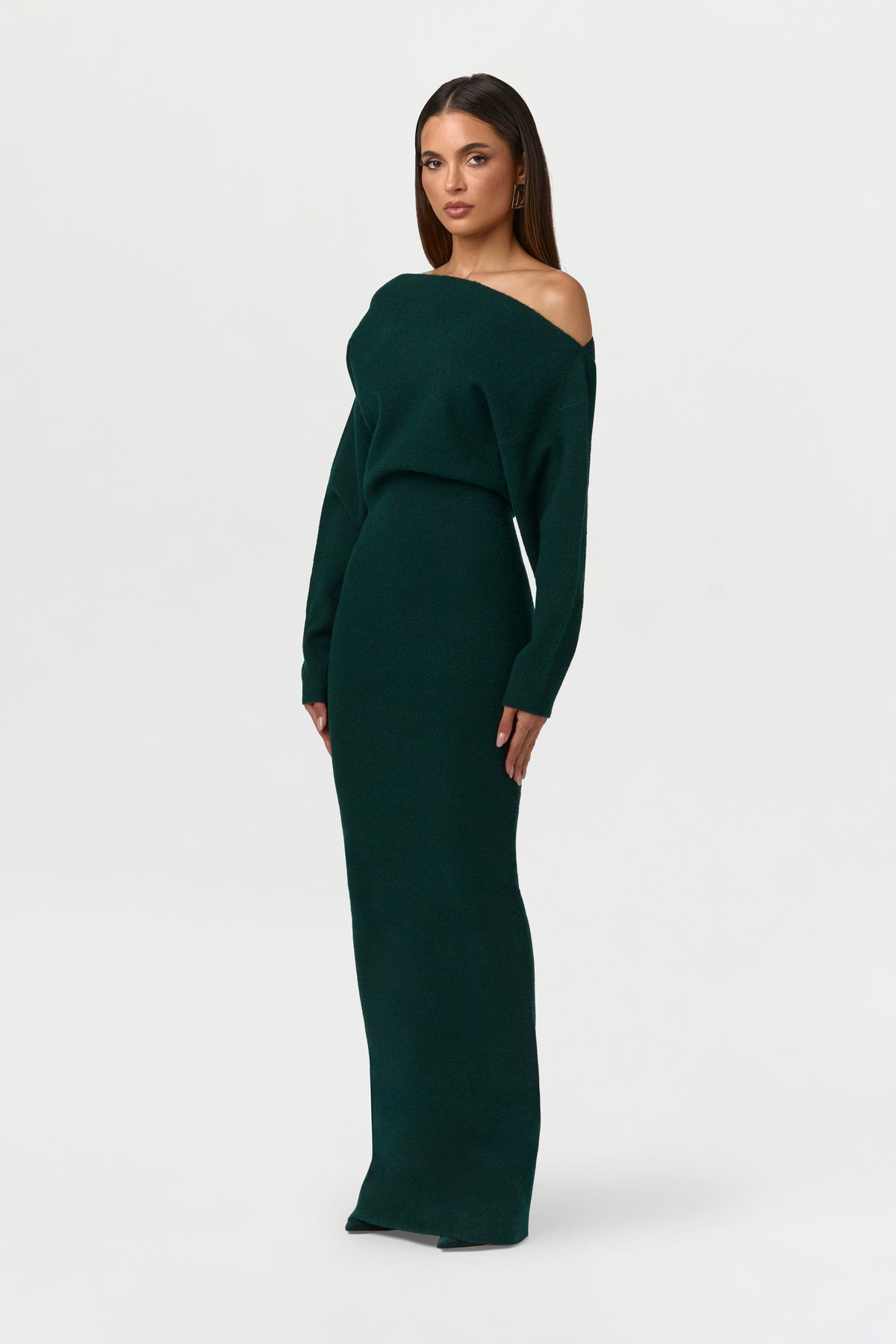 Angled side view of the dark green knit maxi dress, showing the neckline and slim column fit. 13