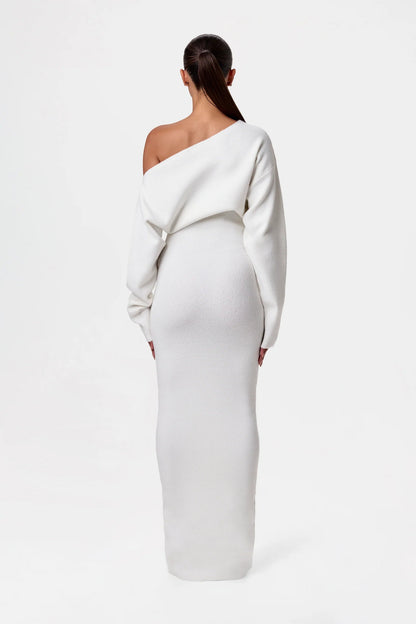 Back view of the cream-white knit maxi dress, showing the asymmetric neckline and fitted skirt. 8
