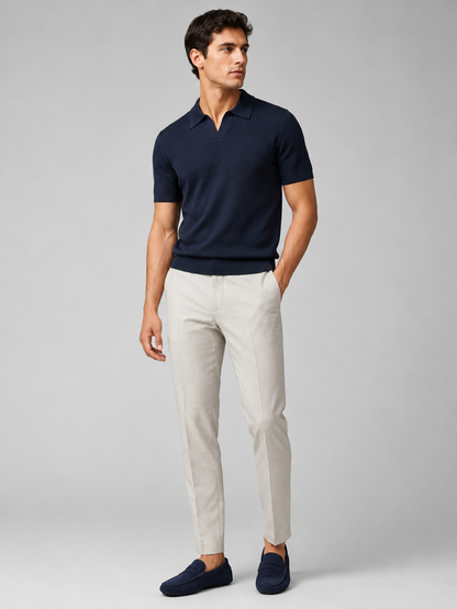 Full-length studio view of model in navy knit polo, light grey trousers and navy suede driving loafers 37