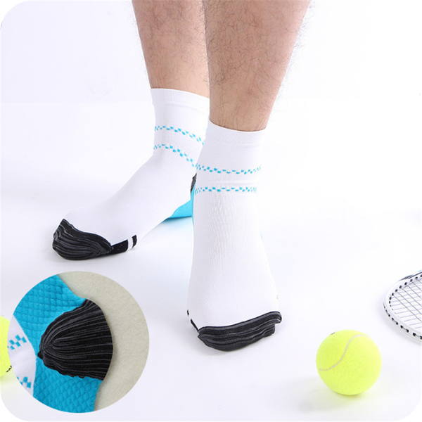 Man standing in white ankle socks with blue dotted stripes beside tennis balls, with an inset close-up of the blue heel. 2