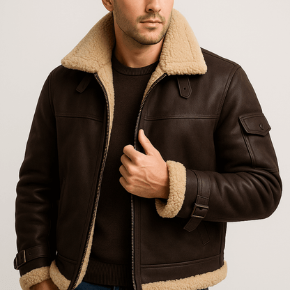 Model wearing the dark brown jacket with shearling collar and cuffs, zipped over a dark crew-neck jumper 2