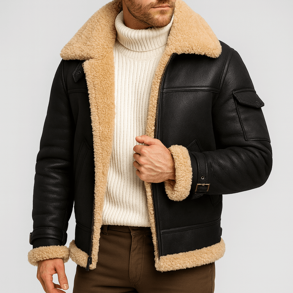 Model wearing the black jacket with thick shearling collar, open over a white roll-neck jumper and brown trousers 4
