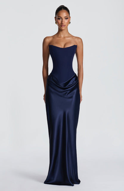 Strapless navy corset gown with draped satin hip detail and gold earrings, front view 6