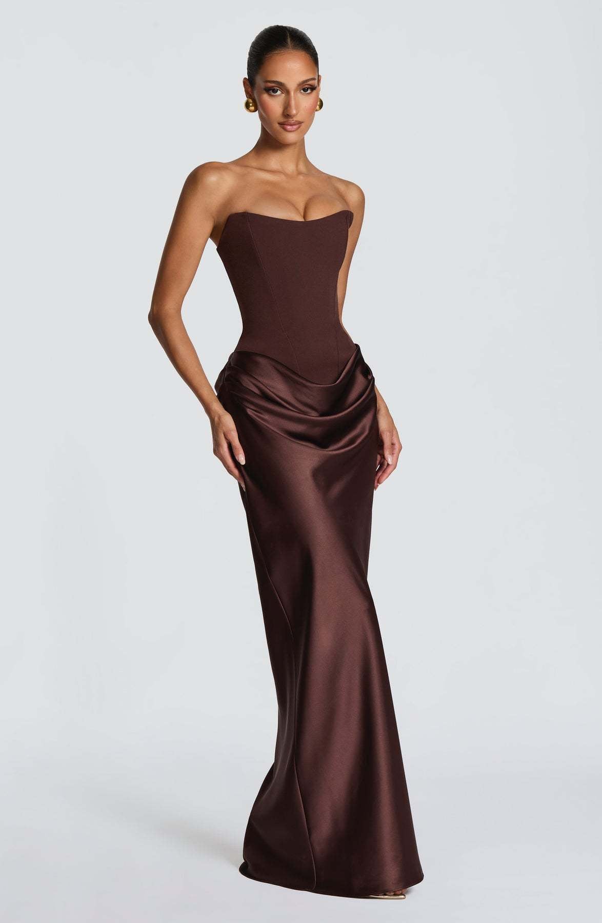 Chocolate brown strapless corset gown with gathered hip drape, shown at a three-quarter angle 12
