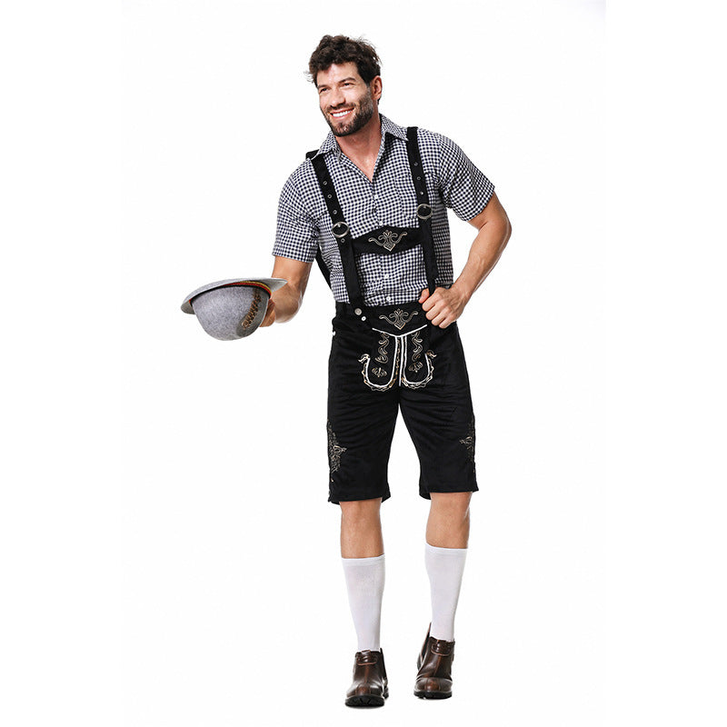 Smiling model holding a grey hat, wearing black checked shirt, black braced shorts, white knee socks and brown boots. 8