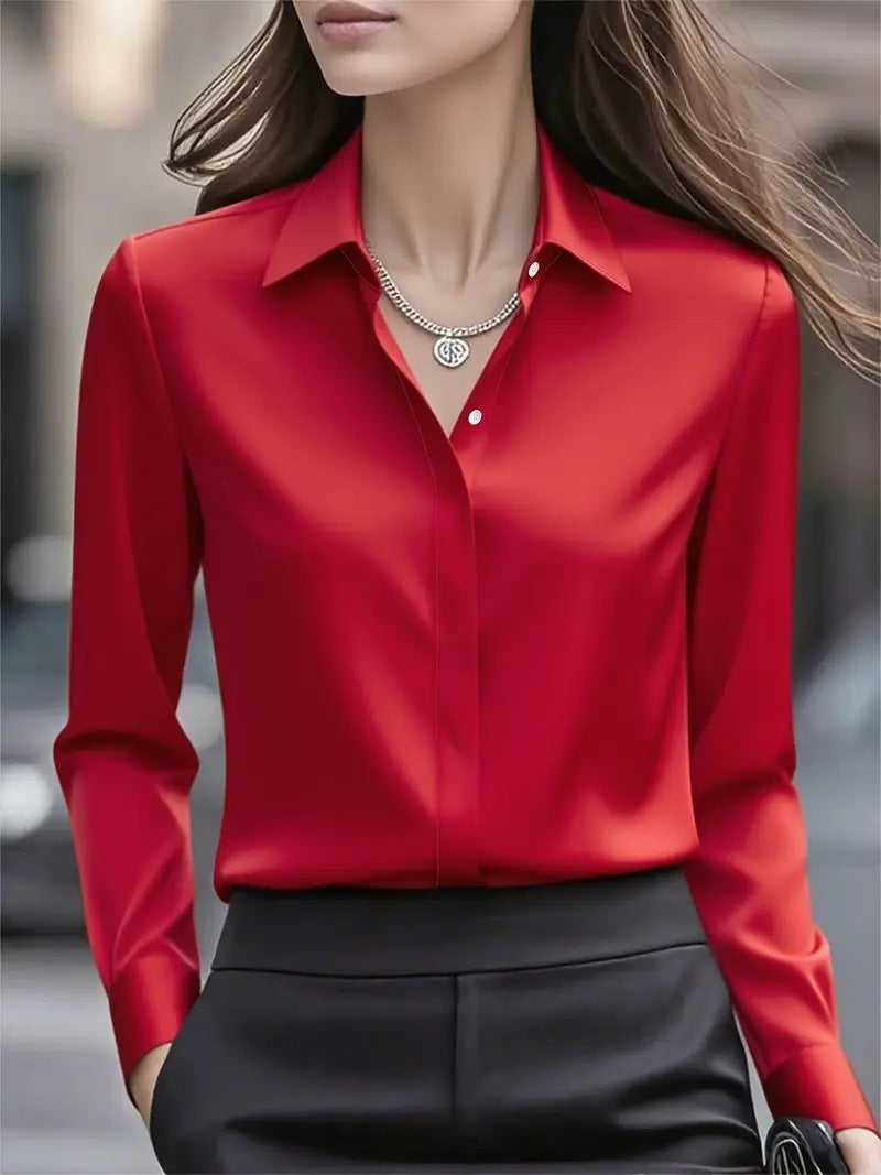 Model wearing the glossy red long-sleeved blouse with a silver pendant necklace and black trousers 4