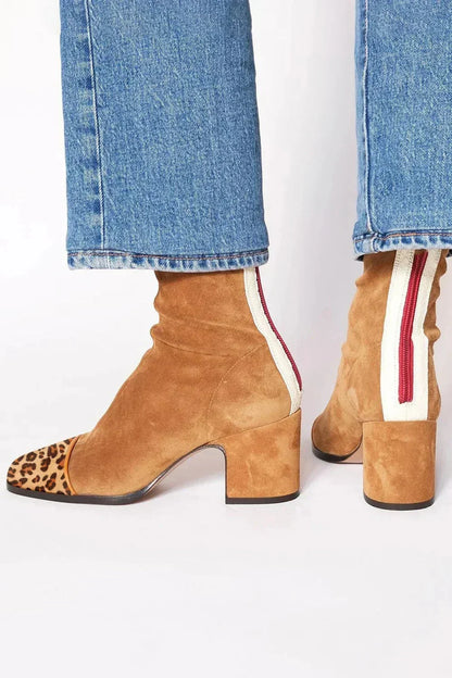 Tan suede ankle boots with a leopard-print toe cap, block heel and cream back panel with red zip, worn with jeans. 6