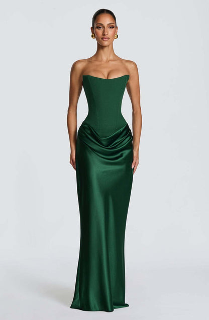 Model in strapless emerald green corset gown with draped satin skirt, front view on grey backdrop 1