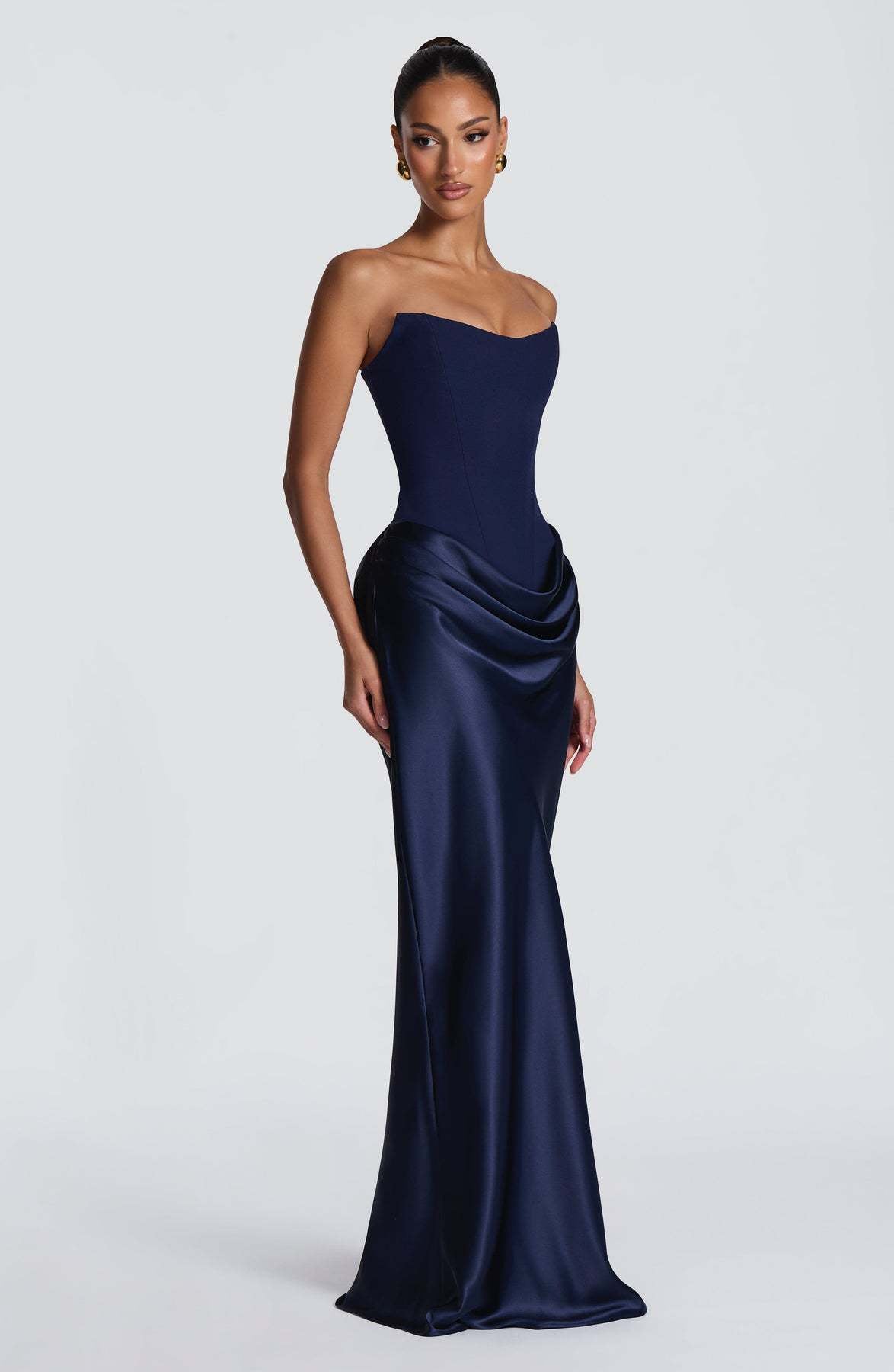 Navy strapless corset gown with satin skirt and hip drape, shown from the side 8