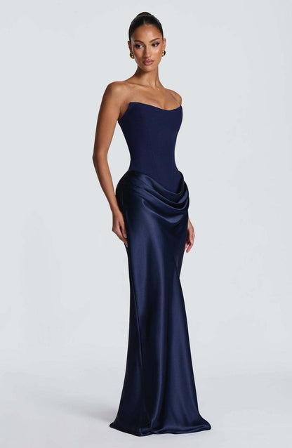 Navy strapless corset gown with satin skirt and hip drape, shown from the side 8