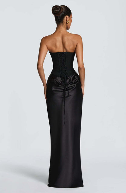 Back view of the black dress showing the lace-up corset back and trailing ties over satin 23