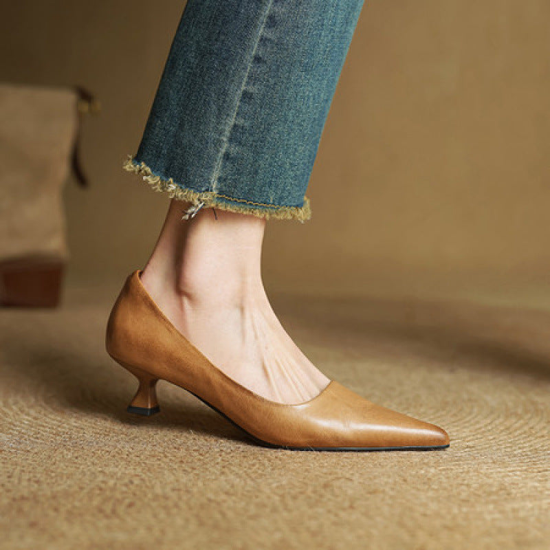 Side view of a tan leather pump worn with frayed jeans, showing the slim flared heel 4