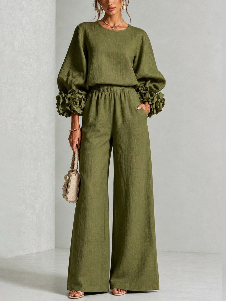 Model standing front-on in the olive green version, with matching flowers on the cuffs and trousers with a pocket 3