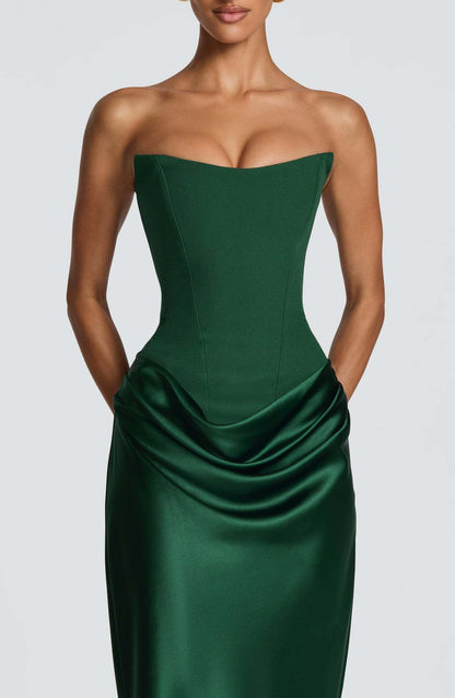 Close-up of emerald green corset bodice and gathered satin hip drape on the model 4