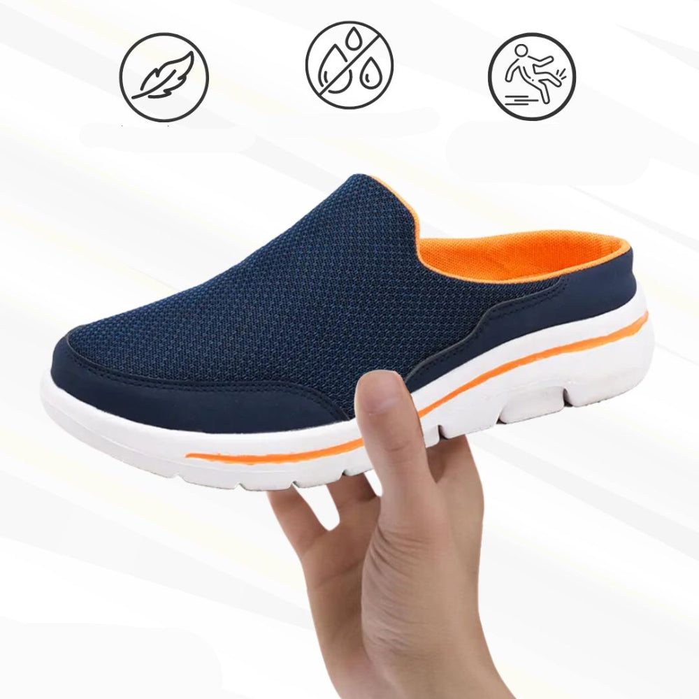 Navy mesh slip-on mule with orange lining and white sole held in a hand, with three small feature icons above. 1