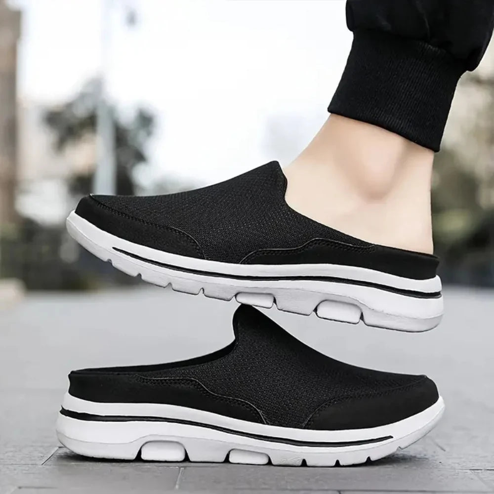 Pair of black mesh slip-ons with white soles, one worn by a model in black joggers on a paved street. 8